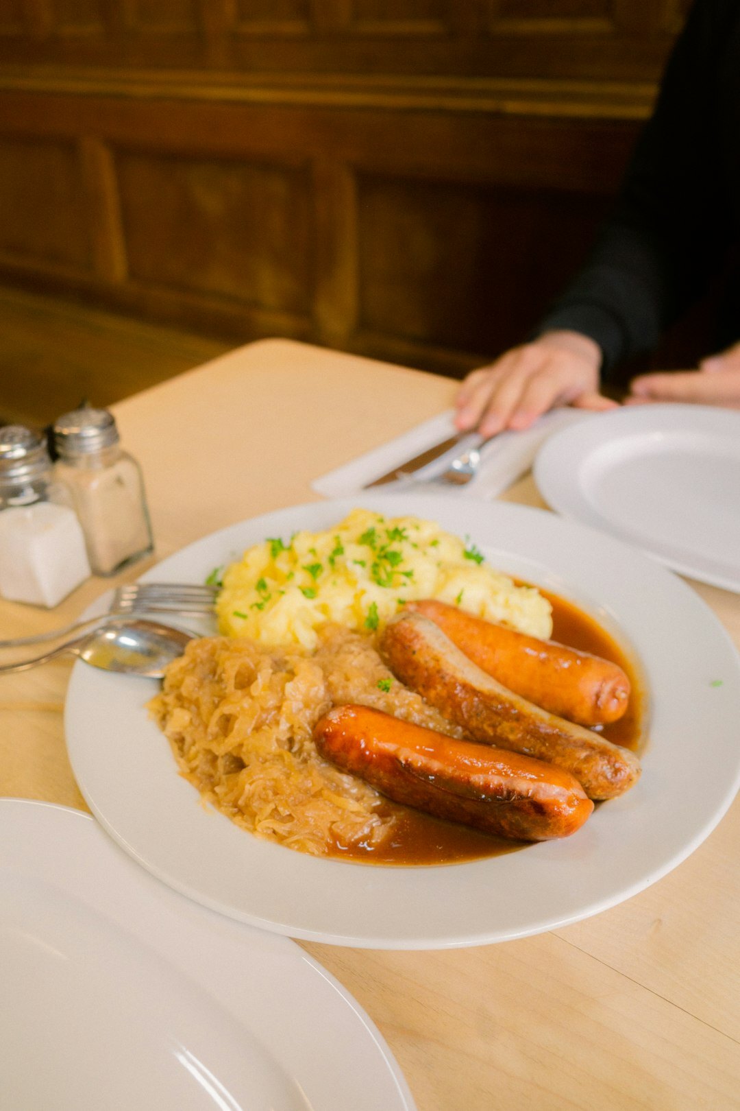 Traditional Czech svíčková with bread dumplings on a rustic wooden table